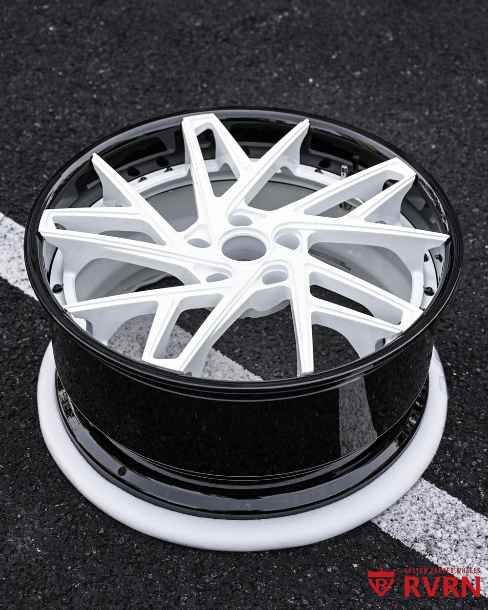Close-up of gloss black barrel and ivory white spokes on RVRN DS74 forged wheel.