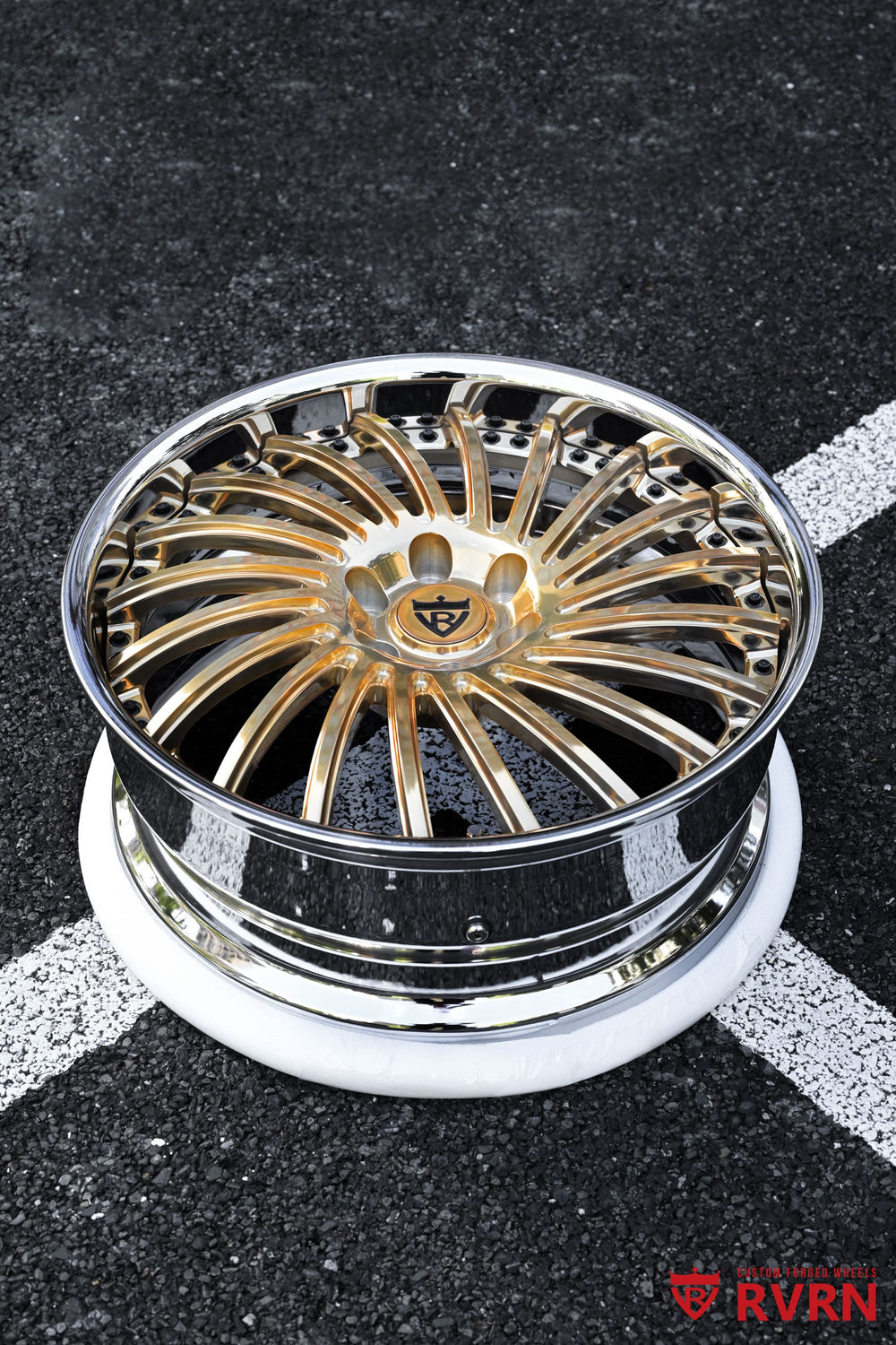 Close-up of polished frozen gold directional spokes on custom GMC Arcadia wheels with chrome barrel and forged 2-piece construction.