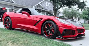 Front view of a red 2017 Corvette C7 Z51 on RVRN RV-DS016 forged wheels with red and black spokes outside a suburban home