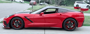 Side profile of a red 2017 Corvette C7 Z51 with large rear wing on RVRN RV-DS016 wheels, red accent spokes, on a street