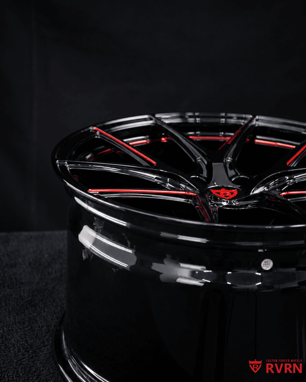 RVRN FORGED engraving on wheel lip of custom Corvette C7 forged wheels with premium Gloss Black finish and red accents.