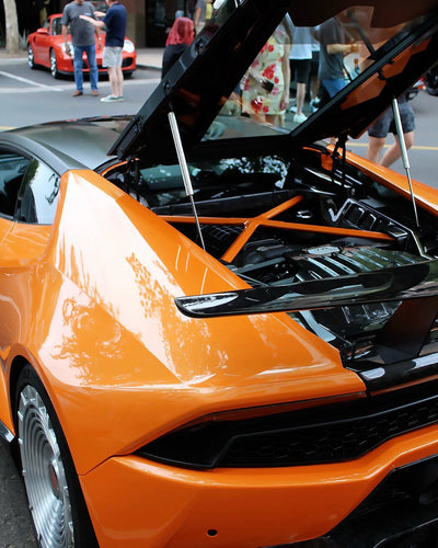 2019 Lamborghini Huracan LP-580 on RVRN RV-MD02 custom forged wheels in Brushed Aluminum finish, rear engine bay open showing V10 engine at outdoor car show.