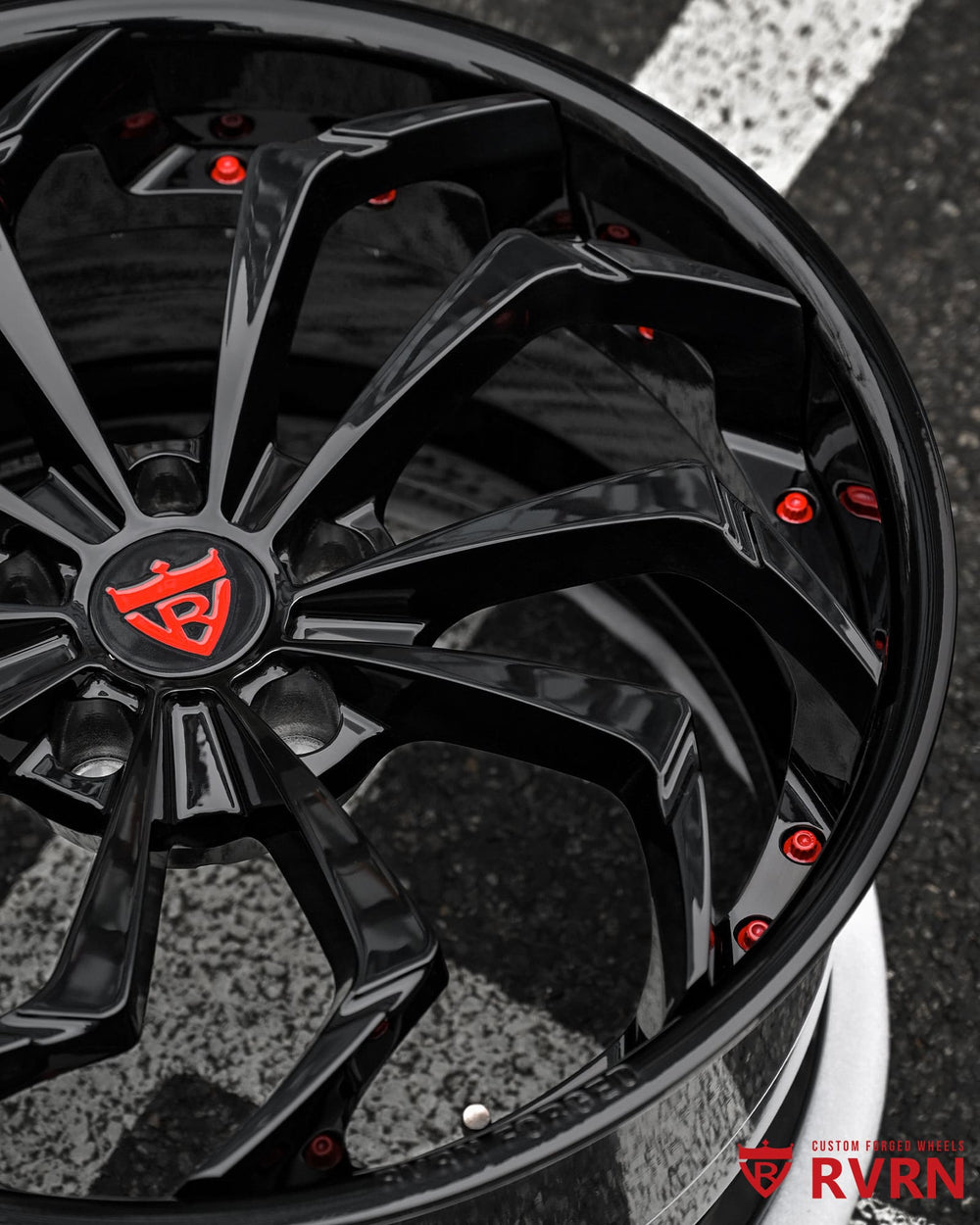 Close-up of RV-DC06 forged wheels showing gloss black spokes, red screws and premium 2-piece forged wheel assembly