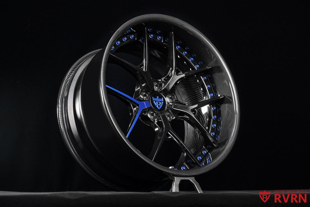 Front view of RVRN RV-DR08D Dodge Challenger rims in 20x9.5 with +6.25MM fitment, gloss black spokes and a single blue accent