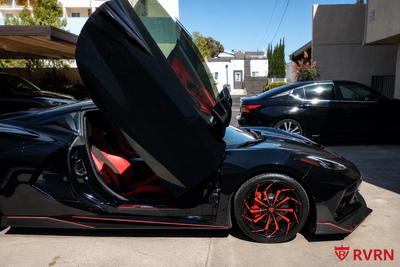Close side detail of a 2020 Corvette C8 Stingray with RVRN RV-DC06 red and black aggressive directional forged wheels and OEM brake setup.