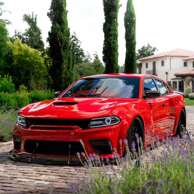 2020 Dodge Charger 392 Scatpack Widebody on RVRN RV-T081 2-piece deep dish custom forged wheels in Gloss Black with RVRN Red Screws, front view on cobblestone driveway with Italian cypress trees.
