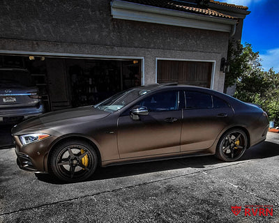 Side view of a 2020 Mercedes AMG CLS 53 on RVRN RV-DF14 5-spoke deep dish custom forged 2-piece wheels with gloss black spokes and barrel plus shiny bronze hardware.
