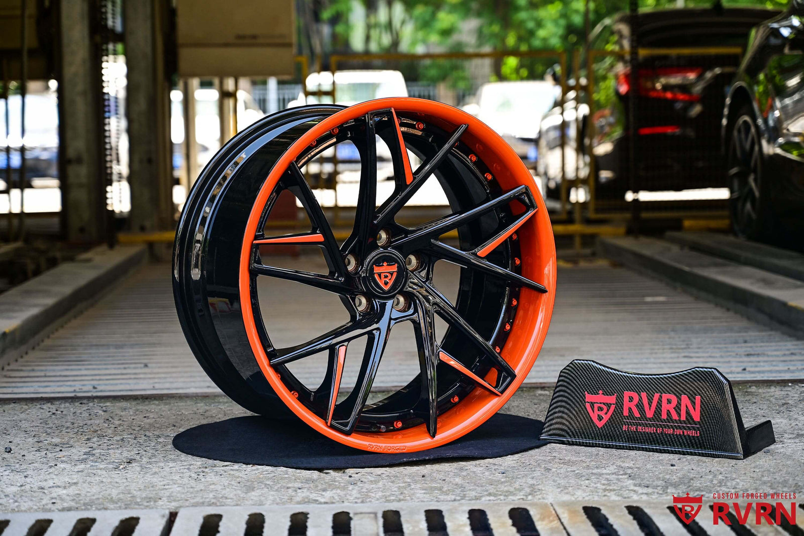 C8 Corvette custom wheels featuring orange and black rims, showcasing a stylish design and vibrant colors.