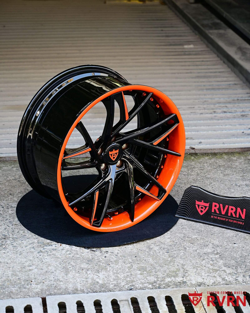 C8 Corvette custom wheels featuring orange and black rims, showcasing RVRN logo on stylish design.