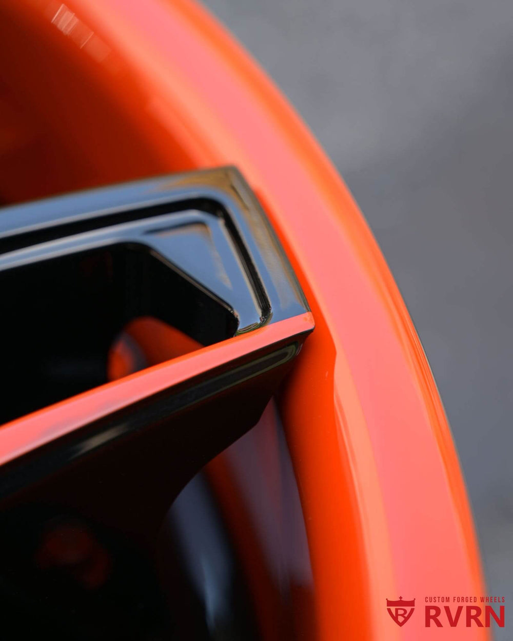 Close-up of c8 corvette custom wheels showcasing orange and black rims with sleek design details.