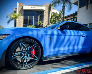 Front fender and wheel detail on a 2022 Ford Mustang GT500 running RVRN RV-MC07 gloss black forged wheels with blue accents.