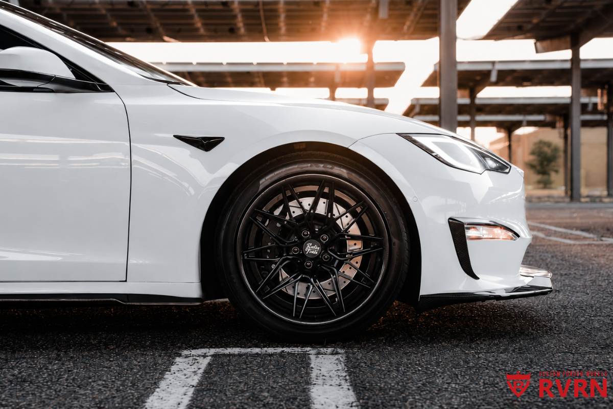 Close-up of the RVRN RV-C081 wheel on a 2022 Tesla Model S, showing the matte black spoke and barrel with carbon fiber wrapping lip.