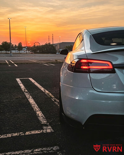 Rear sunset detail of a 2022 Tesla Model S with RVRN RV-C081 matte black custom forged wheels and carbon fiber wrapping lip.