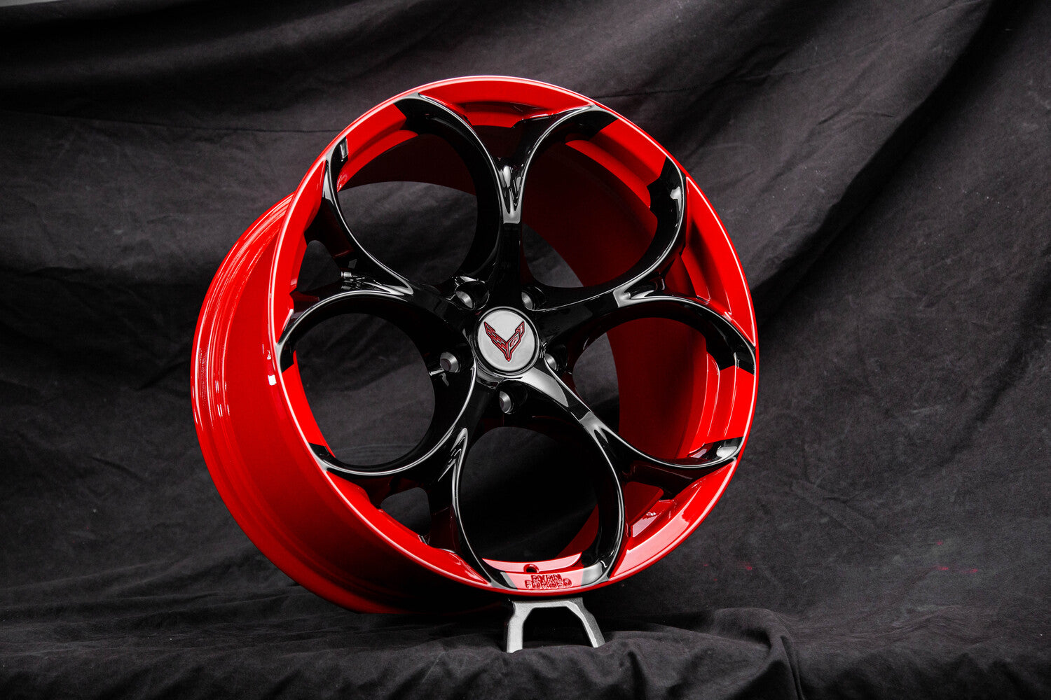 Corvette C8 Z51 forged wheel close-up showing red barrel and black spoke