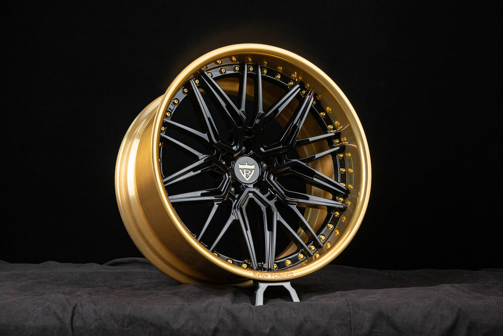 Polished frozen gold barrel and black spoke on deep dish Charger rim