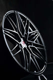 Black custom forged monoblock rim designed for Tesla Model Y with sleek, modern lines and a staggered 21-inch profile.