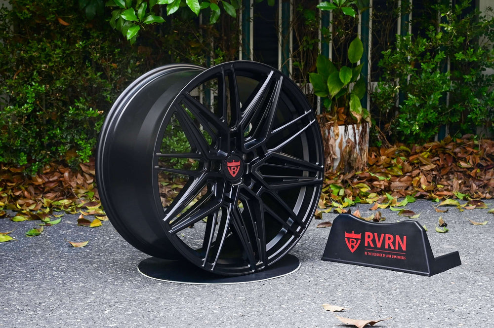 Tesla Model Y performance wheel featuring sleek black custom forged monoblock design on display with RVRN branding.