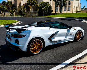 White 2023 Corvette C8 Z51 on RVRN RV-DR16 2-piece custom forged wheels in Brushed Copper Spoke with Chrome Barrel, rear three-quarter view with aggressive wing.