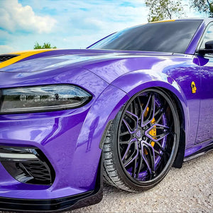 Dodge Charger Widebody with custom forged purple and black deep dish rims showcased against a scenic backdrop.