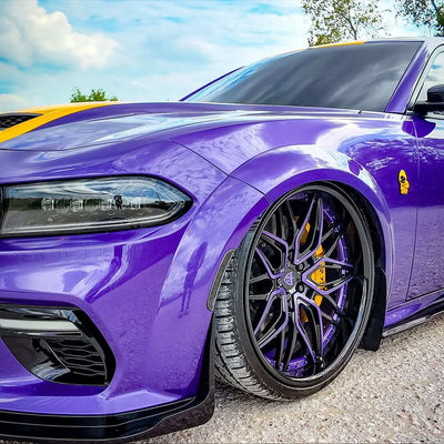 Dodge Charger Widebody with custom forged purple and black deep dish rims showcased against a scenic backdrop.