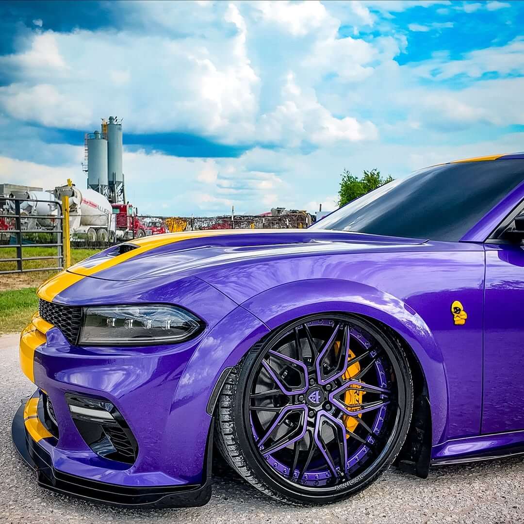 Dodge Charger Widebody with purple paint and black deep dish custom forged wheels, showcasing a striking design.