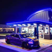 Dodge Charger Widebody with purple and black wheels, featuring deep dish custom forged rims at night.