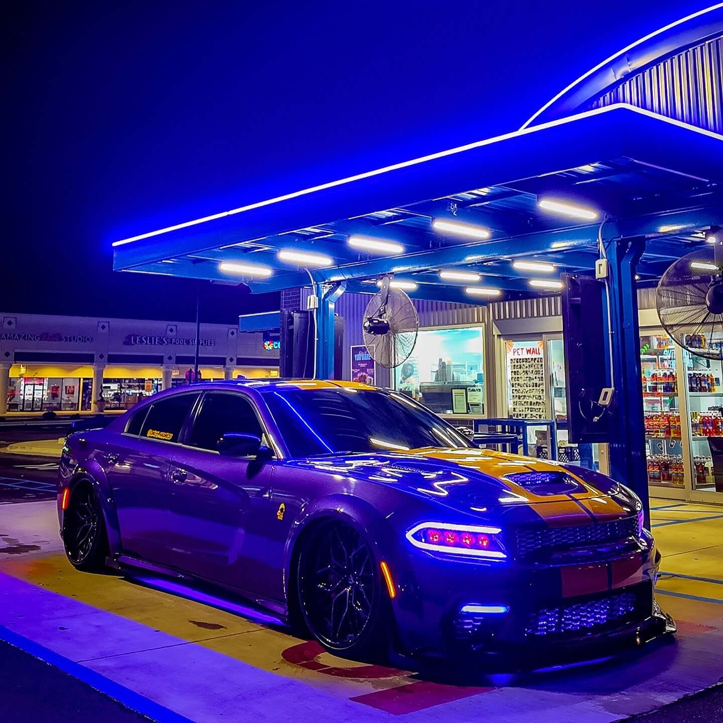 Dodge Charger Widebody in purple with black deep dish rims at a gas station, featuring custom forged wheels.