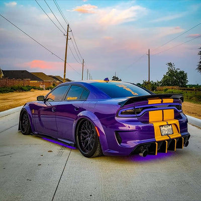 Dodge Charger Widebody with purple and black wheels, featuring deep dish rims and custom forged wheels, parked on a country road.
