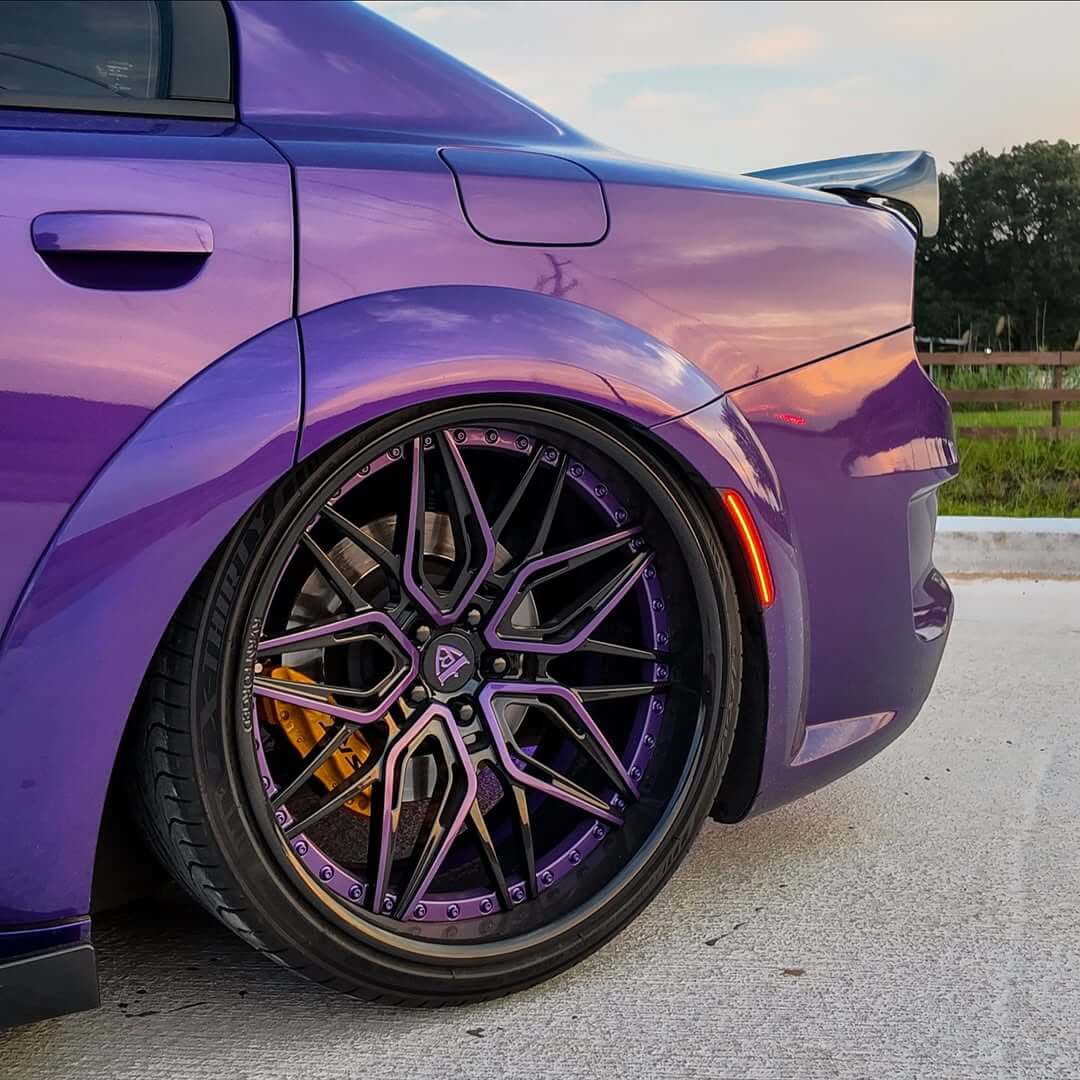 Dodge Charger Widebody with custom forged deep dish rims featuring purple and black wheels.