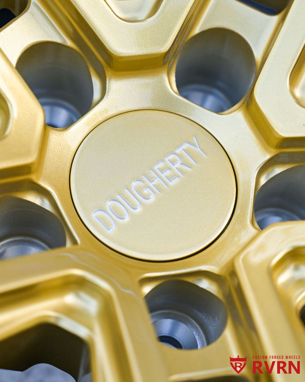 Champagne Gold BMW M4 forged wheels glowing under sunset lighting.