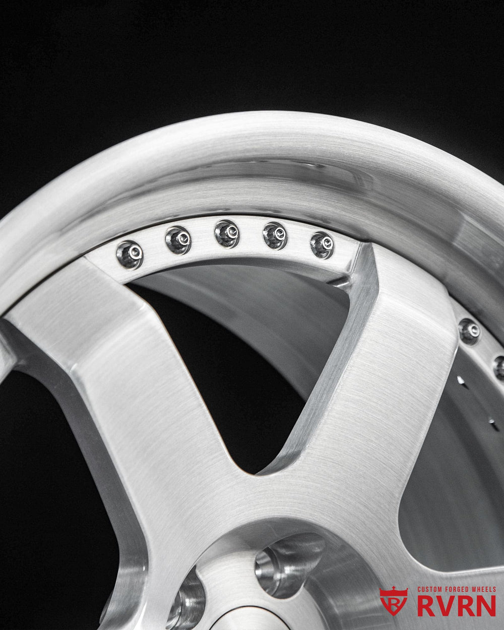Close-up of brushed aluminum 6-spoke RV-DS01 wheel with chrome screws and detailed machining.
