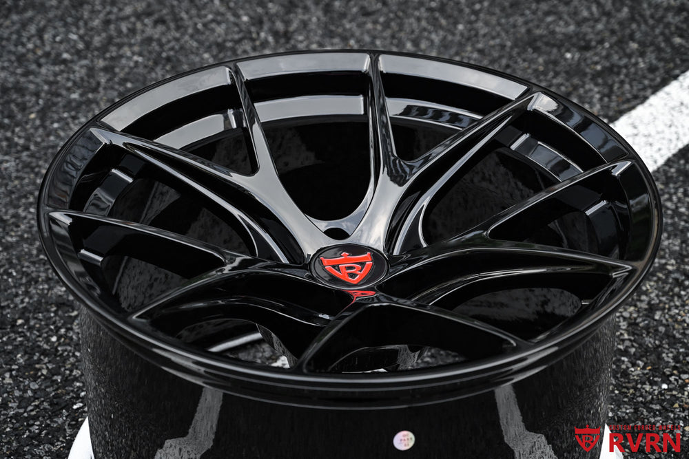 Front three-quarter view of a 2024 Nissan Z NISMO on RVRN RV-MR05 custom forged wheels with a concave Y-spoke design in gloss black, 18x11.5 +15.