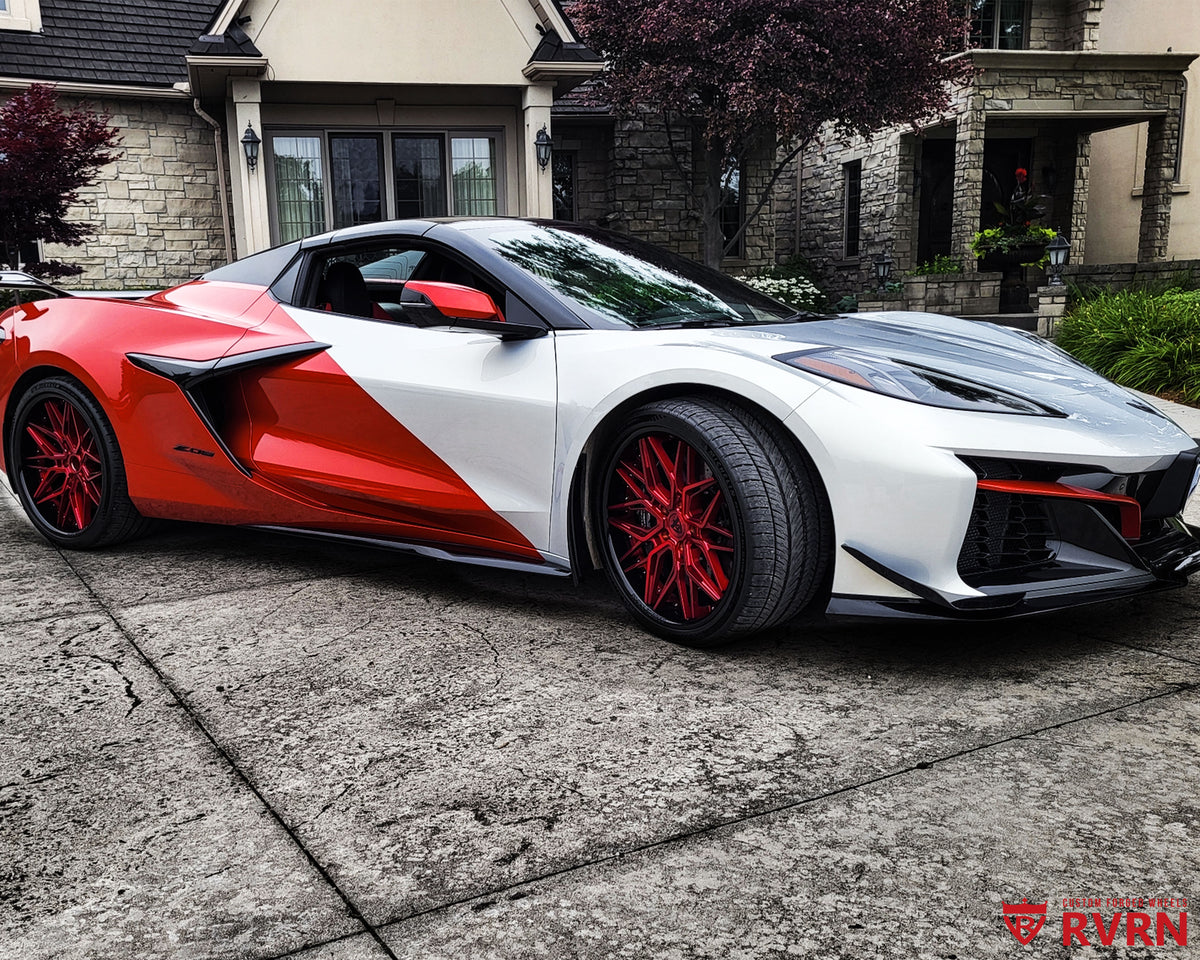 2024 Chevrolet Corvette C8 Z06 on RVRN RV-T081 2-piece deep dish custom forged wheels, front three-quarter view on the driveway showing the nearly flush fitment and red calipers.