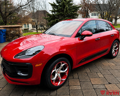 2024 Porsche Macan GTS on RVRN RV-MS016 monoblock custom forged wheels in Polished Aluminum Spoke with color matched Carmine Red Barrel, front three-quarter view on the driveway.