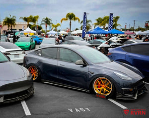 Side show view of a 2024 Tesla Model Y Performance fitted with RVRN RV-DR08 Y-spoke custom forged wheels in transparent dark gold and polished aluminum, 21x9.5 front and 21x10.5 rear.