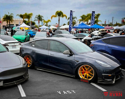 Side show view of a 2024 Tesla Model Y Performance fitted with RVRN RV-DR08 Y-spoke custom forged wheels in transparent dark gold and polished aluminum, 21x9.5 front and 21x10.5 rear.