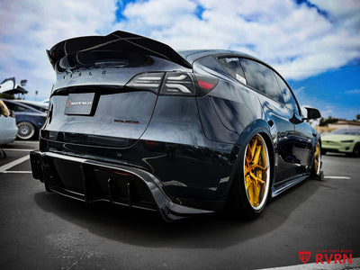 Rear three-quarter view of a 2024 Tesla Model Y Performance with RVRN RV-DR08 Y-spoke custom forged wheels in transparent dark gold and polished aluminum lips, staggered 21x9.5 and 21x10.5 fitment.