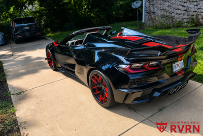 Rear three-quarter view of a 2025 Corvette C8 Z06 on RVRN RV-DR08D custom forged deep dish rims with gloss red fade to gloss black spokes.