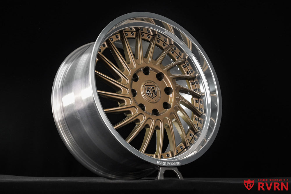 Wheel face detail of RVRN RV-DN01 forged wheels for the 2026 Dodge Ram 2500 Larimer, combining gloss bronze spokes with a polished aluminum barrel in 22x11