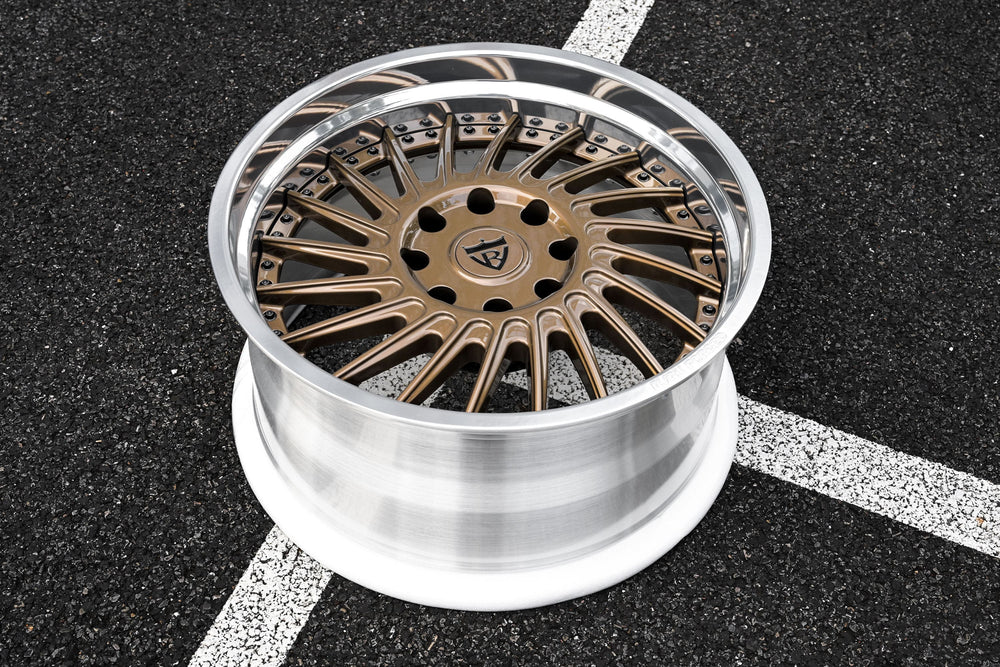 Front three-quarter view of a 2026 Dodge Ram 2500 Larimer on RVRN RV-DN01 two-piece forged wheels, 22x11 +0mm, with deep dish fitment and gloss bronze spokes