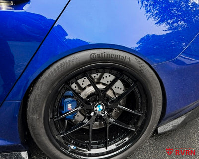 Wheel close-up on a 2026 BMW M5 G90 with RVRN RV-DR08D Y-spoke deep dish custom forged wheels in gloss black and crystal blue engravings.