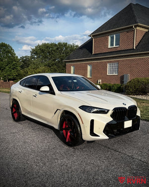 Three-quarter view of a 2026 BMW X6 M fitted with RVRN RV-MC35 red and black two-tone concave 5-spoke custom forged wheels.