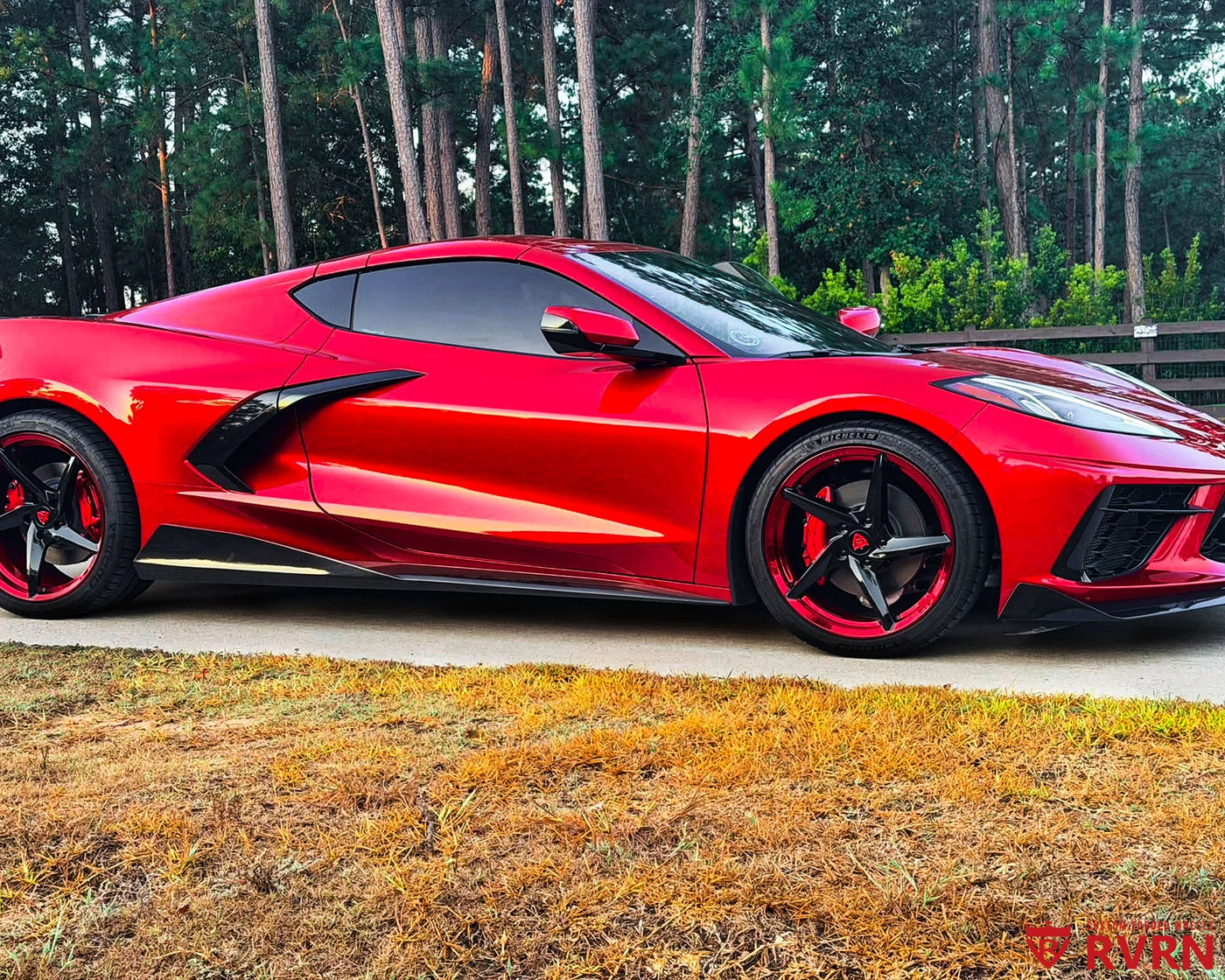 2026 Corvette C8 Stingray on RVRN RV-MC35 monoblock 5-spoke concave custom forged wheels in Gloss Black Spoke with Red Barrel, front three-quarter view on the road.