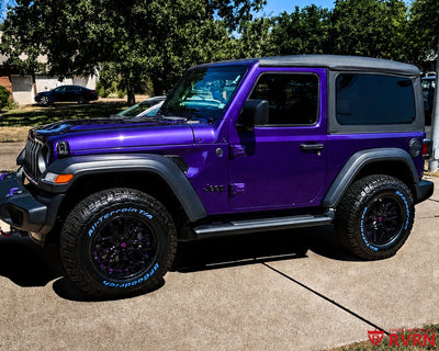Metallic purple 2026 Jeep Wrangler on RVRN RV-T081 2-piece deep dish custom forged wheels in Gloss Black with Grape Purple assembly flange and screws, front three-quarter view on a driveway.