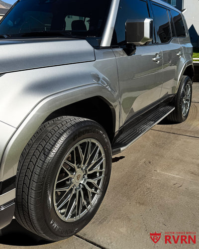 2026 Lexus GX 550 on RVRN RV-MG122 monoblock custom forged wheels in Gloss Gunmetal finish, front wheel close-up with Yokohama Geolandar tires on the driveway.