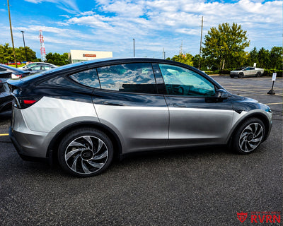 2026 Tesla Model Y Juniper with RVRN RV-MY01 gloss black and machined face custom forged wheels, rear three-quarter view in a parking lot.