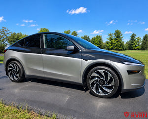 Two-tone 2026 Tesla Model Y Juniper on RVRN RV-MY01 custom forged wheels in Gloss Black with Machined Face finish, front three-quarter view on a tree-lined road.