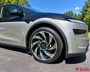 2026 Tesla Model Y Juniper front wheel close-up with the RVRN RV-MY01 Gloss Black and Machined Face custom forged wheel and oversize center cap.