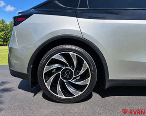 2026 Tesla Model Y Juniper rear wheel close-up with the RVRN RV-MY01 Gloss Black and Machined Face custom forged wheel and oversize center cap.