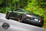 Custom forged wheels on Audi R8 showcasing sleek design on winding road at Tail of the Dragon.